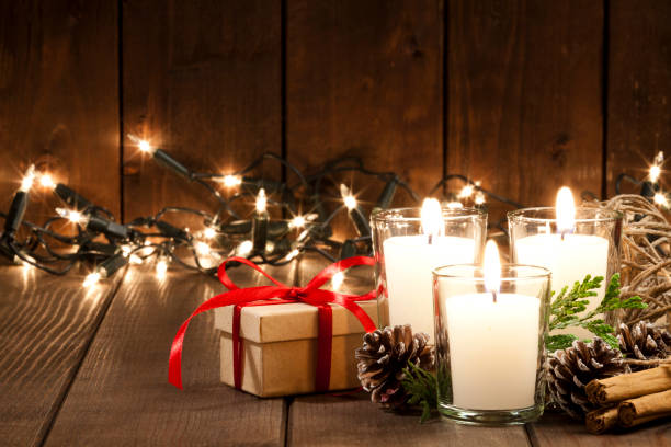 istock Gift box with Christmas candles on rustic wooden table 851888044
