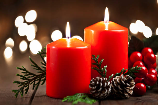 istock Christmas candles on rustic wooden table 851888126