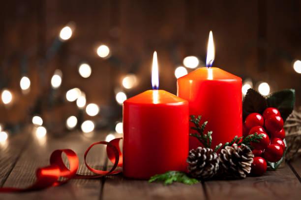 istock Christmas candles on rustic wooden table 851888322