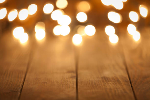 istock Empty rustic wooden table with blurred Christmas lights at background 851888522