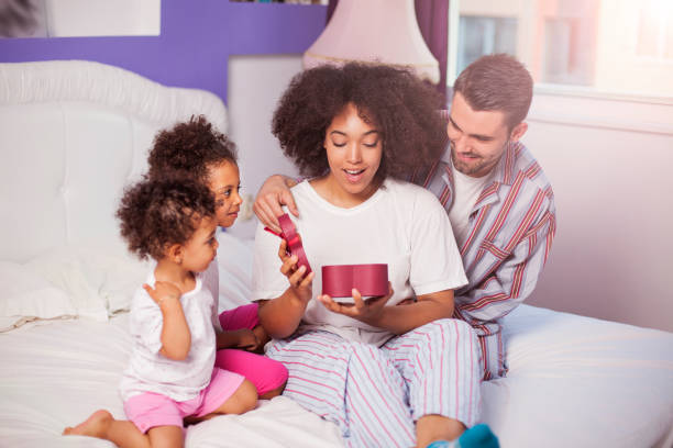 istock Family bringing mother presents in bed 851888746