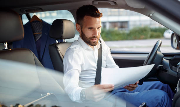 istock Serious man working paper work in the car 851889548