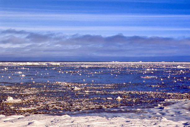 Distant view Hudson Bay, as it begins to to freeze over as the temperature drops.