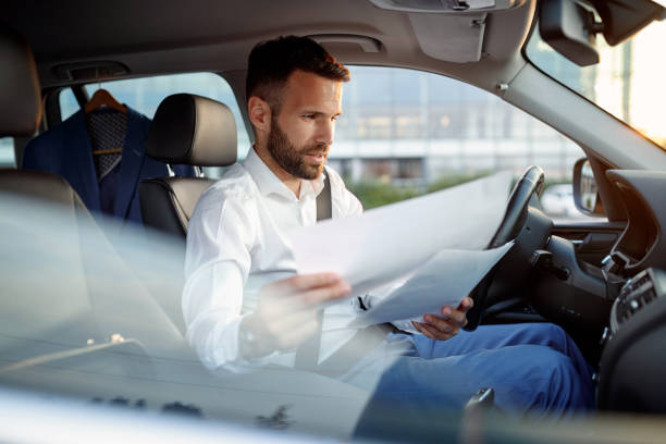istock manager man working on paperwork in the car 851890580