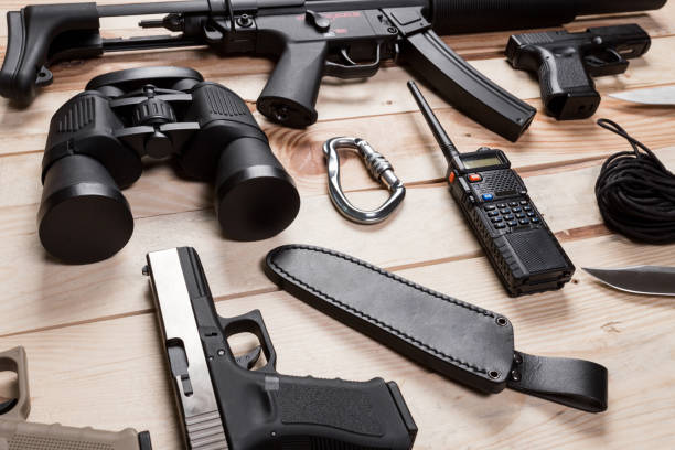 istock Assault rifle, gun, knife with sheath, compass and notebook with pen on table. 851891054
