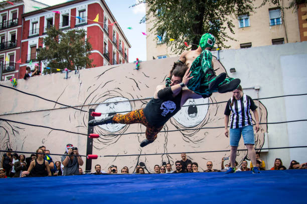 Mexican Wrestling MADRID - SEP 16: Mexican Wrestling at the Great Kermés Mexican Partie of Barley Field in Madrid, Spain on Saturday September 16, 2017. The Kermés Mexican parties usually have a solidarity character. wrestlers uniform stock pictures, royalty-free photos & images