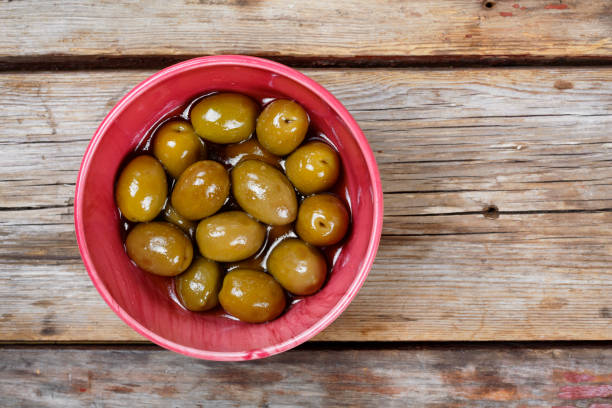 istock Delicious Olives on a wooden background. View from above 851891706
