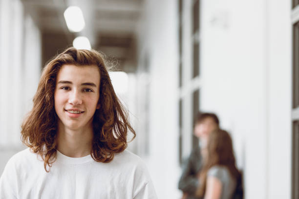 Students In The Hallway Stock Photo - Download Image Now - Long Hair,  Teenage Boys, Boys - iStock