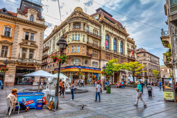 fountain and sanu SERBIA, BELGRADE – SEPTEMBER 19: SANU Knez Mihajlova Street on September 19, 2017 in Belgrade. Fountain, a magnificent SANU building, lots of shops and people, HDR Image. knez mihailova stock pictures, royalty-free photos & images