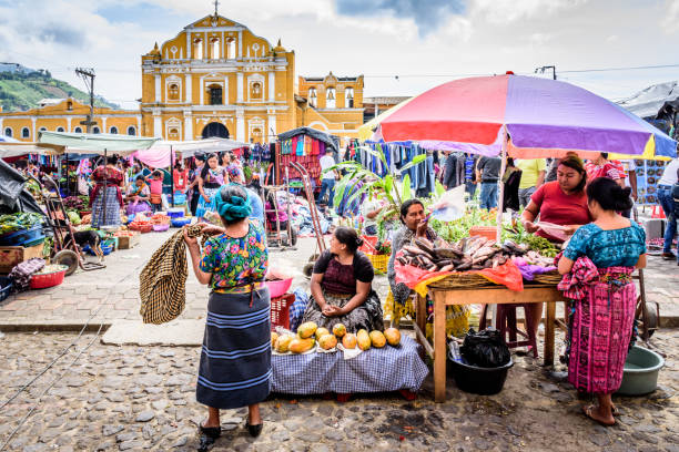 Sunday market in town plaza, Santa Maria de Jesus, Guatemala Santa Maria de Jesus, Guatemala - August 20, 2017: Colorful Sunday market in front of church in small indigenous town on slopes of Agua volcano near UNESCO World Heritage Site of Antigua. guatemala stock pictures, royalty-free photos & images