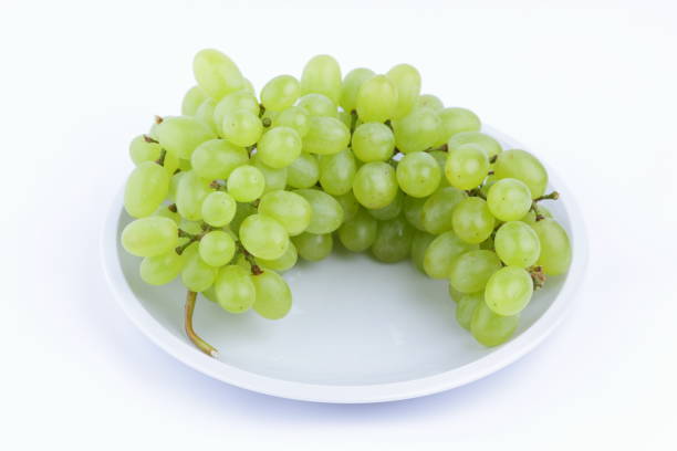 istock Green grapes on a white background on a plate in the minimalism style 851898430
