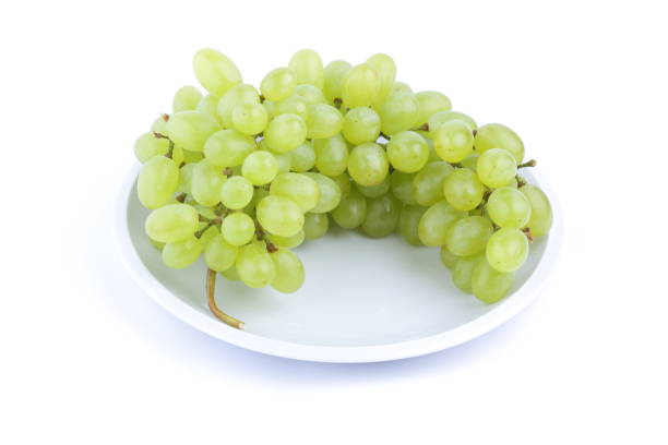 istock Green grapes on a white background on a plate in the minimalism style 851898550