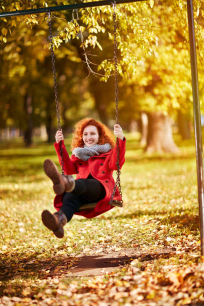 istock Female swinging on a swing in park 851899572