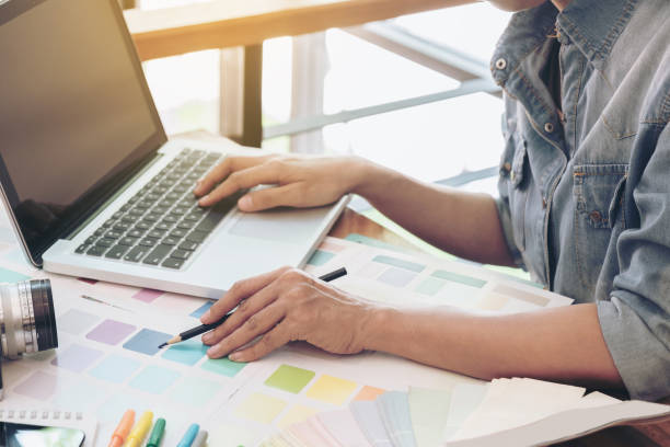 istock Color samples, color swatch samples, Draw architecture, Graphic designer drawing on colour chart, pen at workplace with work example in camera and laptop on wooden desk 851900834