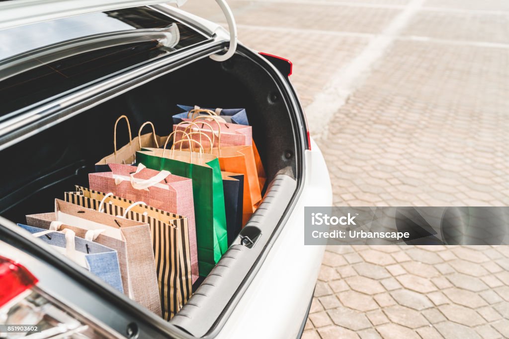 Shopping bags in car trunk with copy space. Modern shopping lifestyle, rish people or leisure activity concept Shopping Bag Stock Photo