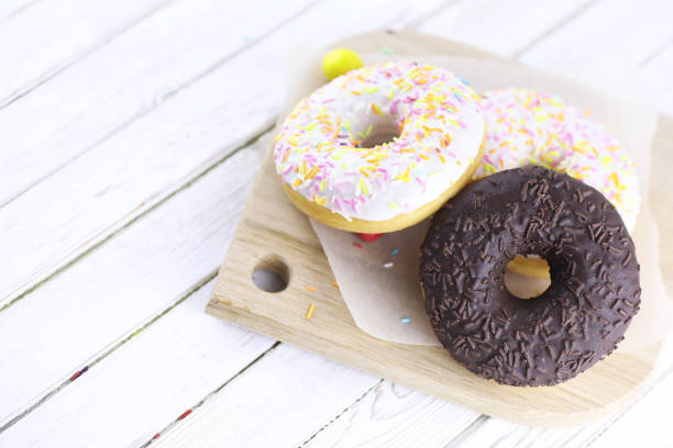 istock Chocolate Donut on a wooden white background 851907616