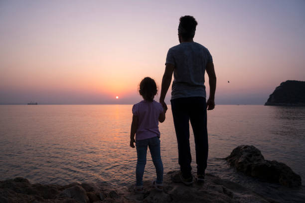 istock Father And Daughter Watching Sunrise 851912176