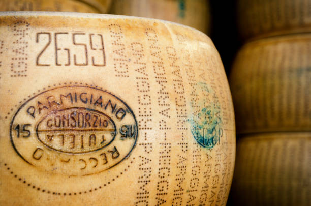 Parmiggiano Reggiano (typical italian cheese) BRA, ITALY - SEPTEMBER 18, 2017: Many Parmiggiano Reggiano (typical italian cheese) wheels stacked toghether in Bra (Piedmont, Italy) on september 18,2017 grana padano stock pictures, royalty-free photos & images