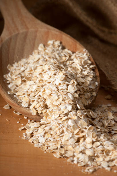 Harina de avena cuchara de madera Vertical Macro - foto de stock