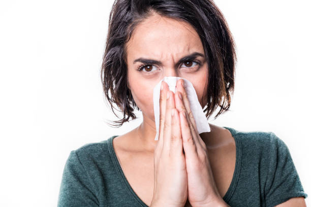 istock sneeze girl having flu on white studo background 851917806