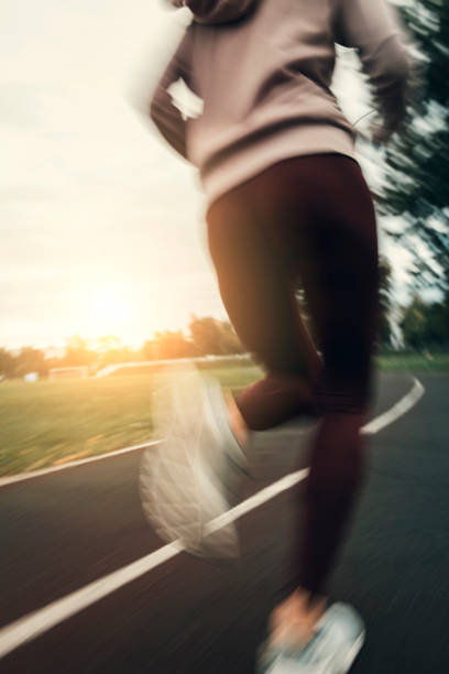 istock woman running on stadium track 851923106