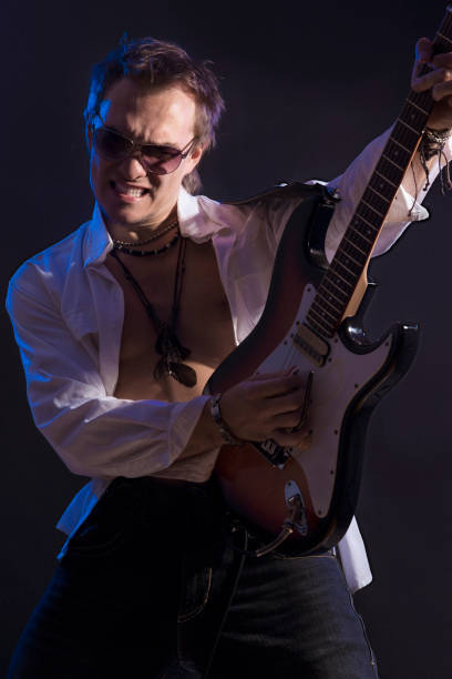 istock Portrait of Male Guitarist Playing with Expression. 851928806