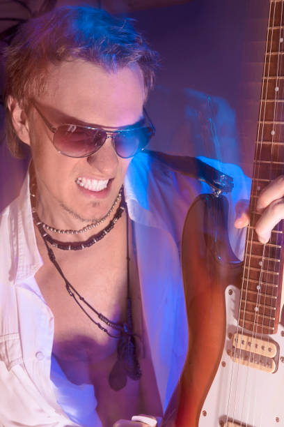 istock Passionate Guitarist Playing with Expression. Shot with Strobes and Halogen Light on Slow Shutter Speed 851928838