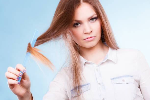 istock Long haired woman combing her hair. 851929732