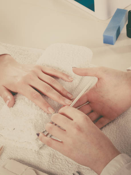 istock Woman getting manicure done file nails 851929960