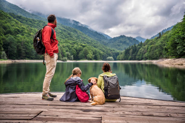istock Family with dog resting on a pier 851930544