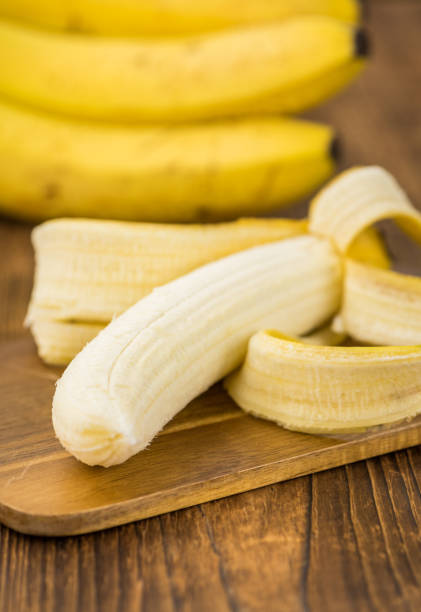 istock Wooden table with Whole Bananas, selective focus 851934492