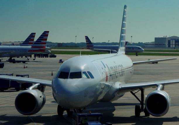 American Airlines aircraft loading, arriving and departing Charlotte, NC--September 20, 2017, American Airlines planes parked and taxing at Charlotte Douglas International Airport jet intake stock pictures, royalty-free photos & images