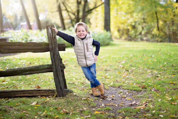 istock boy in autumn season in a park 851938936