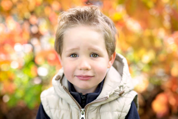 istock boy in autumn season in a park 851939324