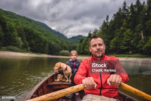 Father And Daughter With A Dog Rowing A Boat Stock Photo - Download Image Now - Active Lifestyle, Adult, Animal