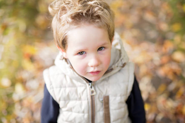 istock boy in autumn season in a park 851940440
