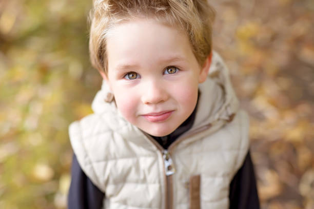 istock boy in autumn season in a park 851940486