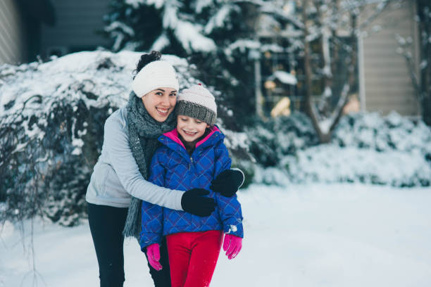 istock Mom and daughter in the snow 851943050