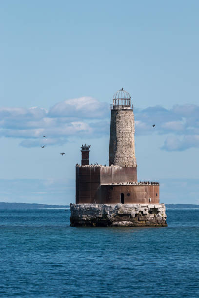 Waugoshance Light Double crested cormorants flying off of the dilapidated lighthouse built in 1851 near a shoal area at the northern end of Lake Michigan. waugoshance lighthouse stock pictures, royalty-free photos & images