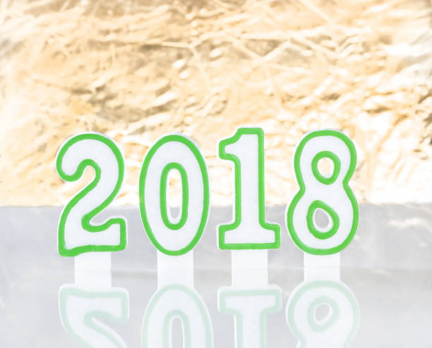 istock Happy New Year candles on glass table with gold background 851949820