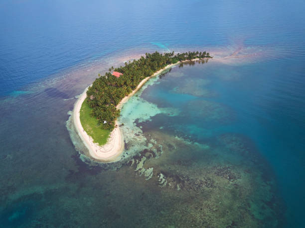 istock One small island in blue sea water 851951428