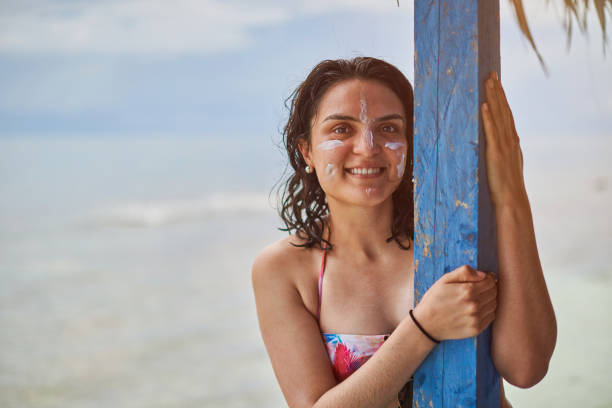 istock Smiling woman with cream on face 851951570