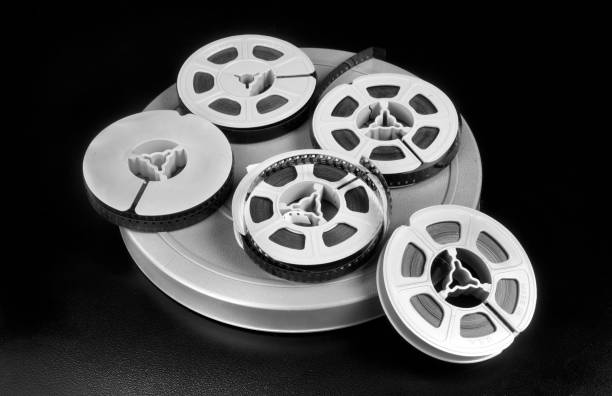 Old 8mm film reels. Old time 8mm film and film canisters in black and white. vintage amateur movie camera stock pictures, royalty-free photos & images