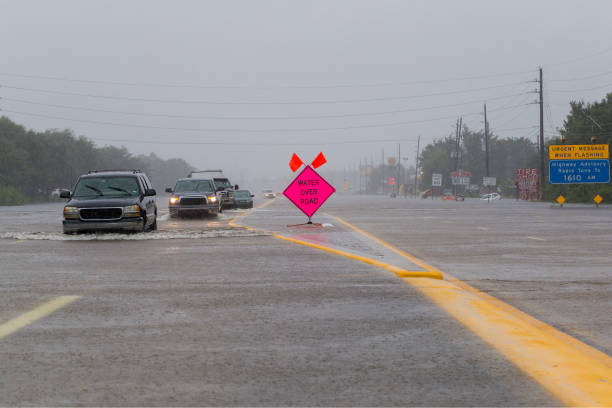 istock Cars drive on flooded highway 851959410