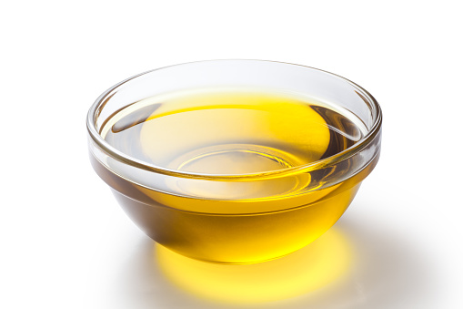 A bowl of olive oil isolated on white background