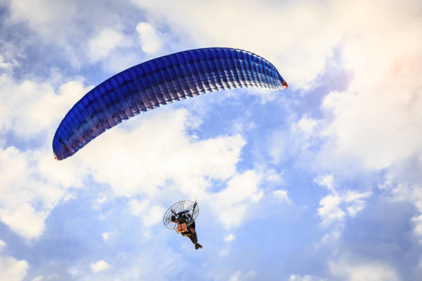 istock Paragliding flying in the blue sunny sky with clouds 851966238