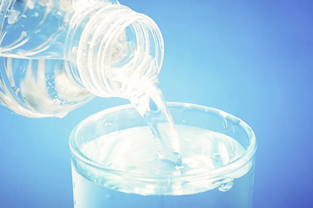 istock Pouring drinking water from bottle into glass 851967140