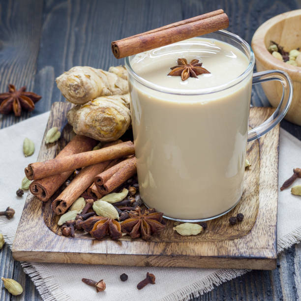 istock Masala chai with spices on wooden background, square format 851979196
