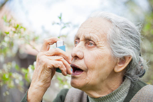 istock Elderly woman having asthma attack, holding a bronchodilator 851981236