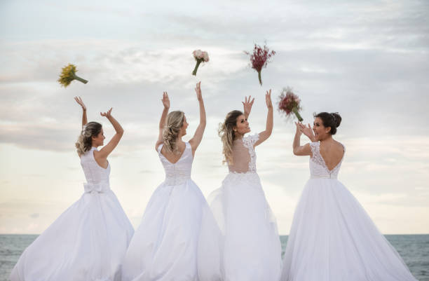 happy brides on the beach - wedding dress bouquet wedding bride imagens e fotografias de stock